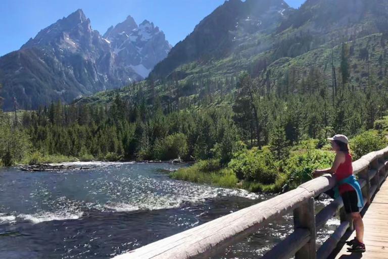 <p>Many visitors at Wyoming's Grand Teton National Park enjoy hiking along the Cascade Canyon Trail. The route is approximately 14-miles and usually takes all day to complete. Along the trail, hikers will pass Hidden Falls and Hurricane Pass. There are incredible viewpoints where hikers can capture the trail's jagged peaks, evergreen forests, and rocky rivers.</p> <p>It's likely for people to notice the huckleberry patches when they start to climb through Cascade Canyon's pristine conifer forest. A short distance later there's a viewing area for an impressive waterfall near the mouth of the canyon.</p>