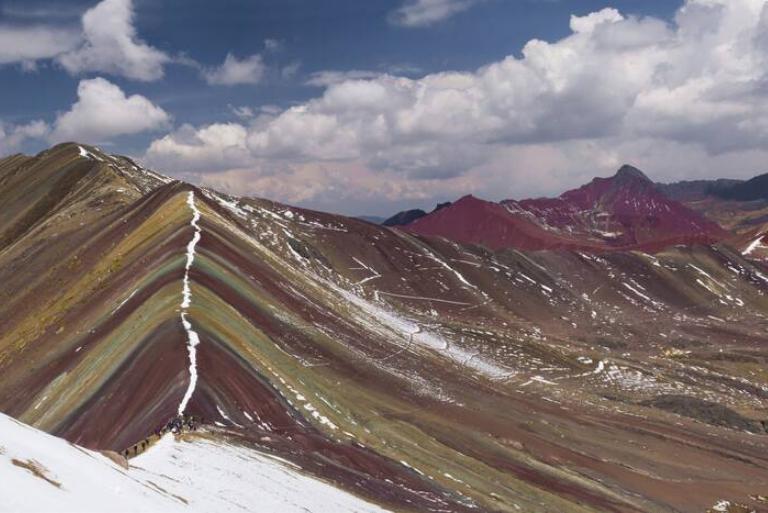 <p>In photos like this, Peru's Rainbow Mountain features breathtaking colors and appear like a painting that people can actually step into. As <i>Reader's Digest Australia</i> mentioned, however, staff there weren't prepared for the sudden uptick of 1,000 people climbing the mountain at once thanks to social media impressions.</p> <p>Not only is the attraction now packed with people, but many of them are ill-prepared to take on the high-altitude journey. Worst of all, however, is the fact that people who go to the trouble aren't likely to see the same dazzling colors in person. When it's cloudy, the Rainbow Mountain looks closer to a regular mountain.</p>
