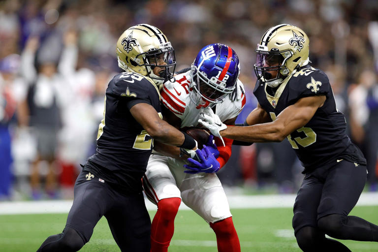 New York Giants wide receiver John Ross catches a touchdown pass despite double coverage by Saints DBs Paulson Adebo (29) and Marcus Williams (43) during an NFL football game, Sunday, Oct. 3, 2021, in New Orleans. (AP Photo/Tyler Kaufman)