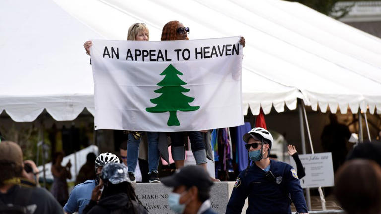 People carry an "Appeal To Heaven" flag as they gather to support President Donald Trump during his visit to the National Constitution Center to participate in an ABC News town hall on September 15, 2020, in Philadelphia.