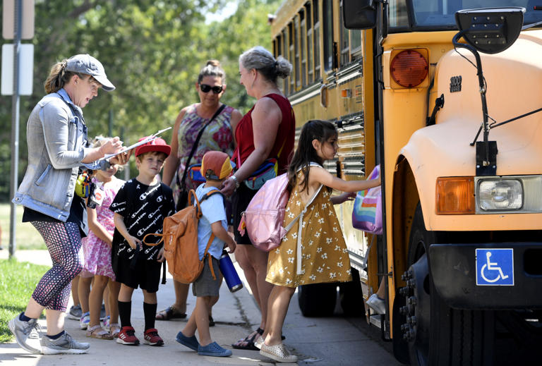 Kids board the school bus outside of Stephen Knight Center for Early Education as the school closed early due to extreme heat on September 7, 2022 in Denver, Colorado. Stephen Knight Center of Early Education is one of more than 30 public schools in Denver without air conditioning that released students early this week or closed entirely due to the record-breaking heat wave sweeping through Colorado.