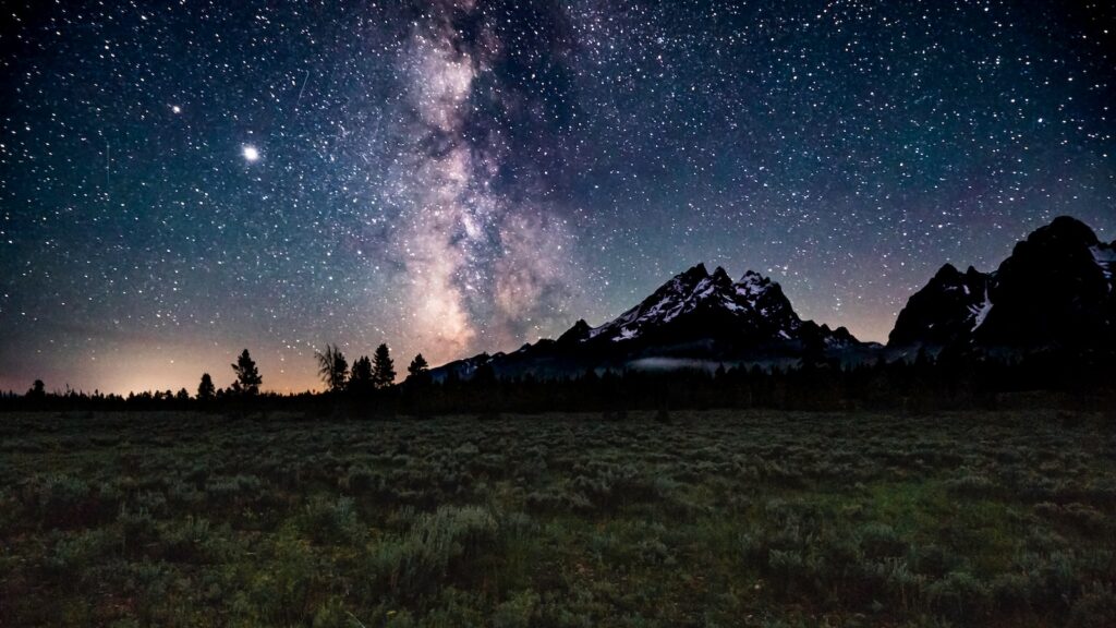 <p>In an area surrounded by mountains and national parks, it is no surprise that the night skies here are incredibly dark. This makes it a wonderful area for star gazing and astrophotography, with the mountains serving as the perfect backdrop to the Milky Way as it arcs across the night sky.</p><p>Just be on the lookout driving home as the park’s animals often make their way up to the roads at night, and the last thing you want is to end up on the wrong side of a bison!</p><p><strong>More Articles from Roam the Northwest</strong></p><ul> <li><a href="https://roamthenorthwest.com/10-of-the-best-places-to-spot-wildlife-in-the-grand-tetons/">10 of the Best Places to Spot Wildlife in the Grand Tetons</a></li> <li><a href="https://roamthenorthwest.com/visiting-jackson-hole-with-kids/">A Budget-Friendly Guide to Visiting Jackson Hole</a></li> </ul>