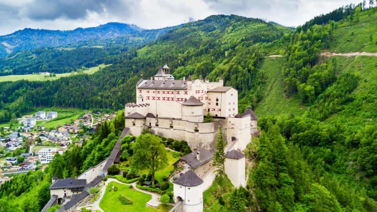 <p>Hohenwerfen Fortress is a real-life fairytale castle perched atop a cliff overlooking an enchanting Austrian town. Its roots date back to 1077, and it has served as a fortress, prison, hunting lodge, and even a film set for <em>Where Eagles Dare</em>, starring Clint Eastwood. </p><p>Nestled among the trees at 623 meters high, it offers breathtaking views of the Salzach Valley and surrounding mountains. <a href="https://www.salzburg.info/en/sights/excursions/hohenwerfen-fortress#:~:text=Opening%20times,April%20until%20beginning%20of%20November.">Open from April to November</a>, the castle welcomes visitors with extended hours in the peak summer months.</p>