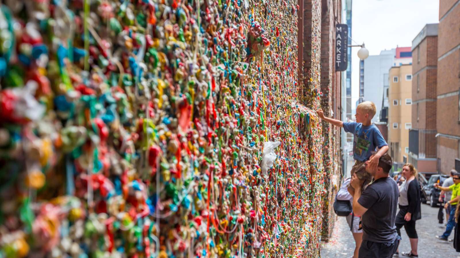<p>Since the early 1990s, people have been sticking gum on this 50-foot long wall, located outside the main entrance of Pike Place Market. In 2015, over 2,350 pounds of gum were removed, taking over 100 hours to clean. Despite the efforts, the wall is still covered in gum and continues to attract visitors.</p>