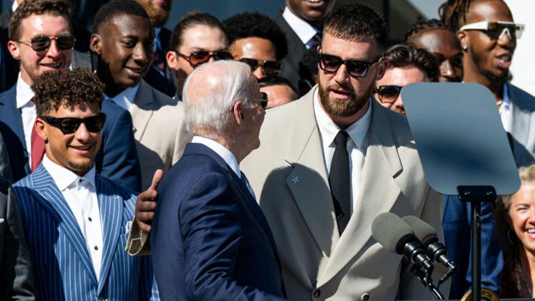 Kansas City Chiefs quarterback Patrick Mahomes looks on as Biden speaks with tight end Travis Kelce. - Saul Loeb/AFP/Getty Images