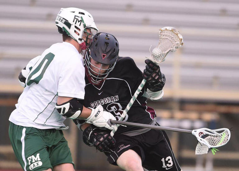Corcoran's Sean Eccles charges through Jake Pulver of Fayetteville-Manlius. Section III Class A Boy's Lacrosse Semifinals at Cicero-North Syracuse High School, Thursday May 22, 2014. Scott Schild | sschild@syracuse.com Scott Schild | sschild@syracuse.