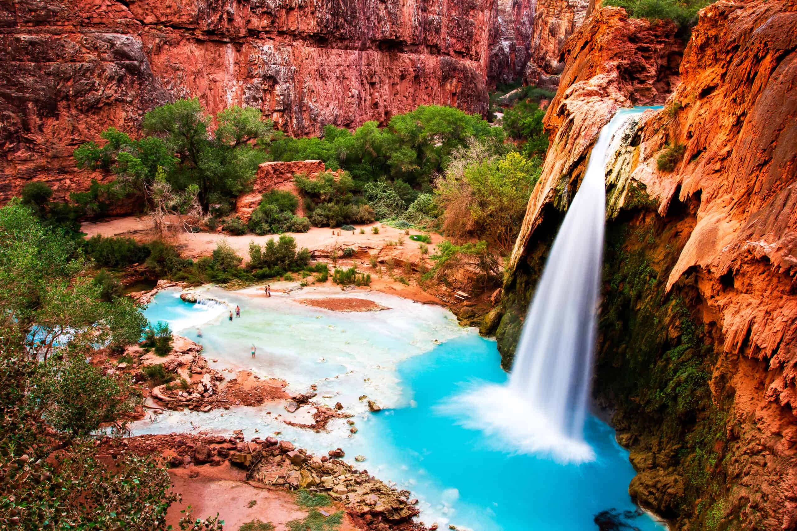 <p>Nestled within the Havasupai Reservation, Havasu Falls is famous for its dazzling blue-green waters that create an amazing contrast against the red rock canyon. Dropping around 100 feet into picturesque turquoise pools, this iconic waterfall is a must-see in the Grand Canyon region. </p> <p>A permit is required to visit, and the 10-mile hike to reach the falls adds an adventurous twist to your summer travels. The effort is well worth it, as Havasu Falls offers unparalleled natural beauty and a deep connection to the cultural heritage of the Havasupai people.</p>