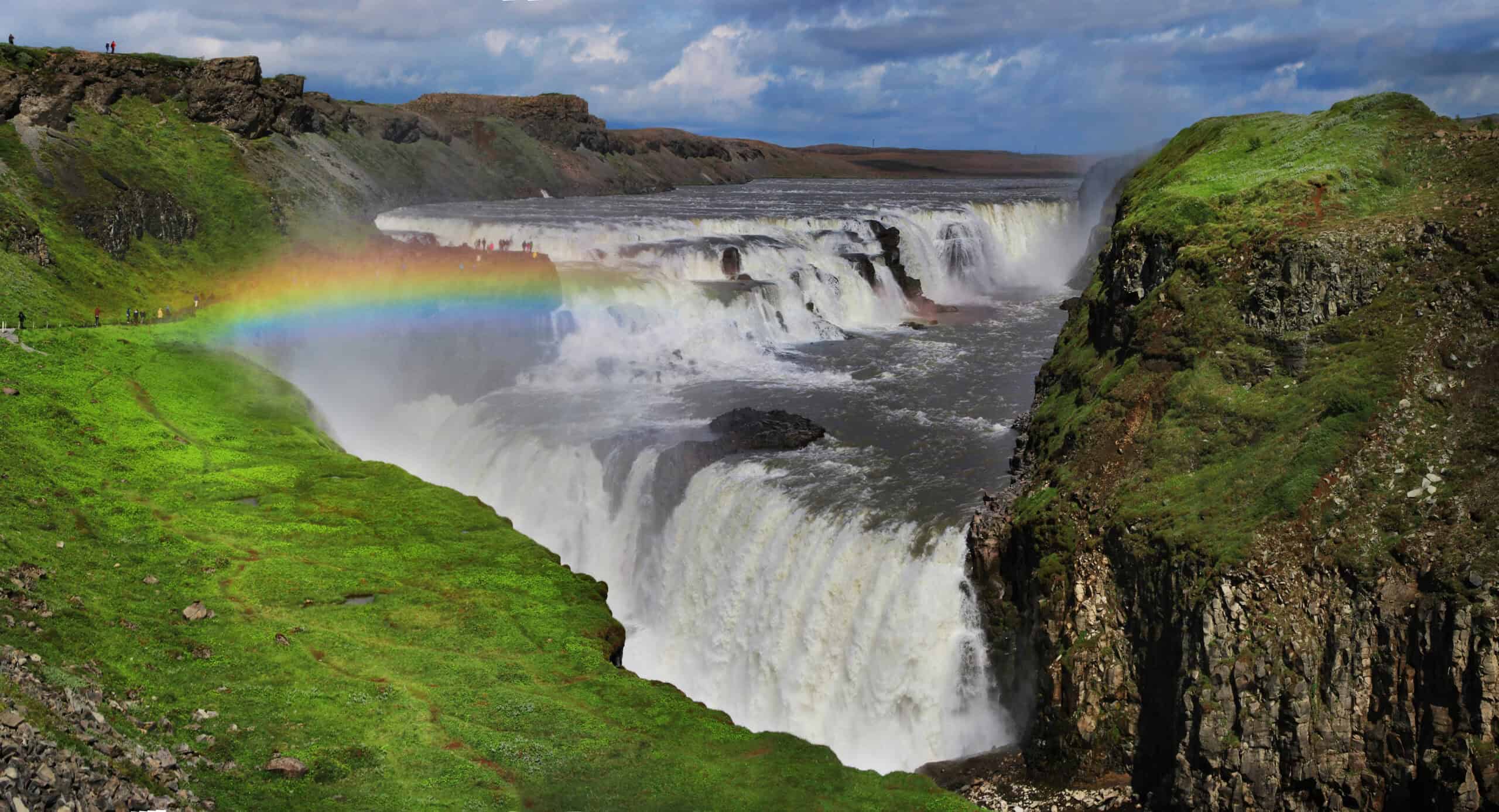 <p>Located within Iceland’s famed Golden Circle, Gullfoss is one of the country’s most powerful and enthralling waterfalls. This iconic natural wonder features a dramatic double cascade, with water plunging 36 feet in the upper tier and 69 feet in the lower tier into a rugged canyon. </p> <p>The golden hue that often appears in its waters, especially on sunny days, and the frequent rainbows created by the mist, make Gullfoss a breathtaking sight. Fed by the Hvítá River from the Langjökull glacier, the falls are easily accessible and offer several viewpoints for visitors to marvel at its awe-inspiring beauty.</p>