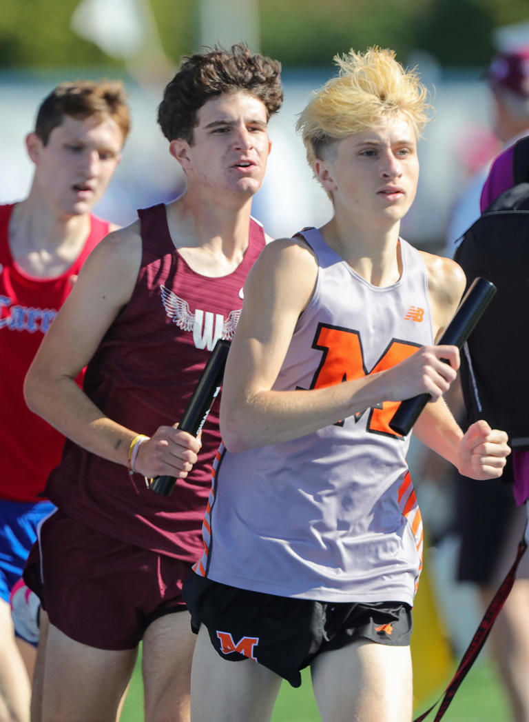 Woodridge’s Caiden Jensen, left, and Marlington’s Michael Nicholls compete in the 3,200-meter relay in the Division II state track & field championships, Friday, May 31, 2024, in Dayton.