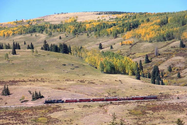<p>If you want to explore Colorado through the eyes of 19th-century gold and silver miners, hop on the <i>Cumbres & Toltec Scenic Railroad</i>. The locomotive zigzags through 64 miles of forests, the San Juan mountains, and the border of New Mexico. At its highest point, the train climbs 10,015 feet up a mountain! (Don't worry; it's only a 4% rise.)</p> <p>If you ride in the deluxe parlor car, you'll see that the coach glimmers with Victorian design and a golden shimmer. Keep your eyes out, and you may spot some elk or bears among the aspen trees.</p>