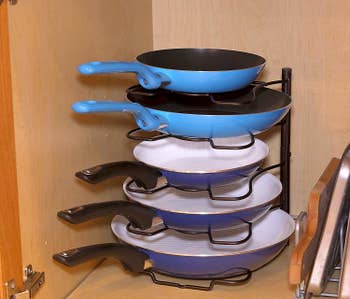 the rack sitting upright holding a stack of pans