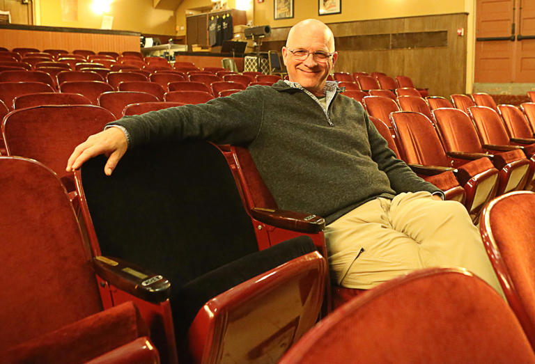 Peter Hoopes, a board member of The Everett Theatre, sits next to a chair in the theatre dedicated to Robin Williams on Wednesday, May 15, 2024. The actor/comedian sat in that seat 35-years-ago when scenes for the movie 'Dead Poets Society' were filmed there.