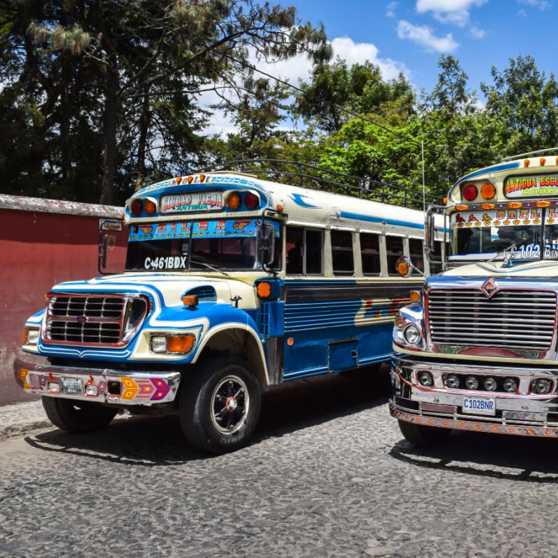 Chicken buses are the main form of local transportation in Guatemala. They're old American school buses, and yes, you might see passengers transporting chickens and other live animals onboard. While chicken buses are extremely cheap, I don't recommend traveling on them solo, especially long distances, because there are sometimes issues with theft. It's better to pay more and take one of the many tourist shuttles that crisscross the country for a safer ride. You should also avoid traveling on the roads in Guatemala at night and stick to daytime journeys only - more crime including robberies and carjackings happen at night.