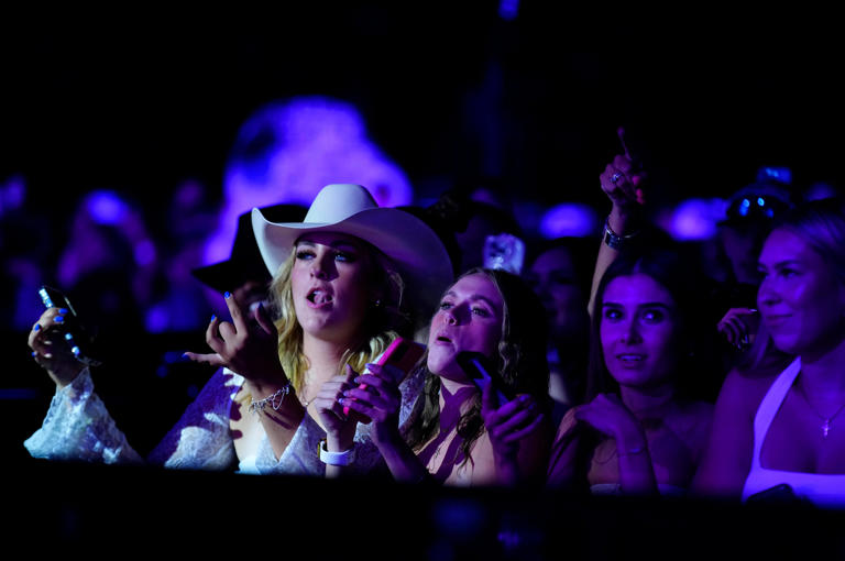 Fans listen and sing along while Luke Combs performs during a concert at State Farm Stadium on May 31, 2024.