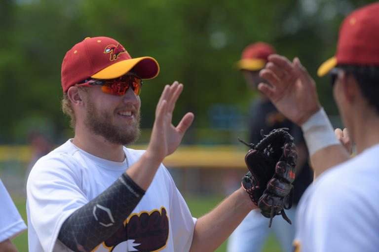 In this file photo, Fort Collins Foxes player Dylan Norsen is high-fived after making a catch to end an inning during the season-opener at City Park on June 5, 2021.