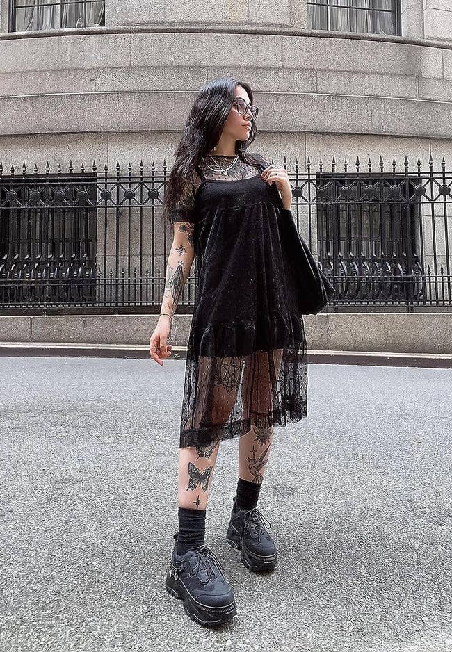 reviewer in the cover up dress with a mini black dress underneath
