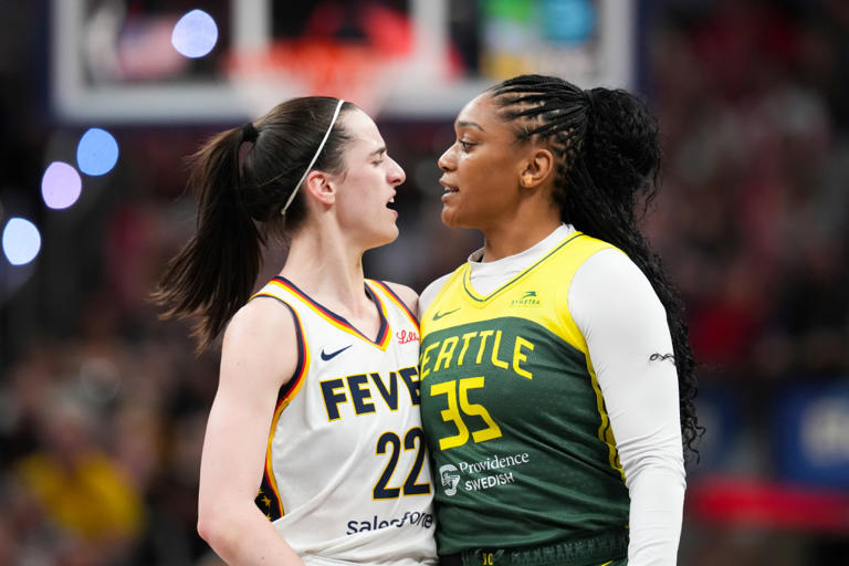 Indiana Fever guard Caitlin Clark (22) talks to Seattle Storm guard Victoria Vivians (35) following being run into after making a three-pointer, Thursday, May 30, 2024, during the WNBA game at Gainbridge Fieldhouse in Indianapolis. Joe Timmerman/IndyStar / USA TODAY NETWORK