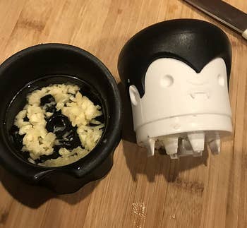 a reviewer photo of the head removed and crushed garlic inside