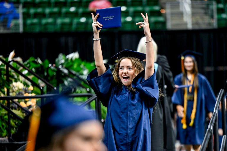 Graduate Lucy Bosworth celebrates after receiving her diploma during the Haslett High School graduation ceremony on Sunday, June 2, 2024, at the Breslin Center on the Michigan State University campus in East Lansing.