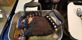 reviewer photo of the claws stuck inside a large hunk of cooked pork