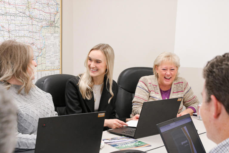 Tracey Bramble, right, laughs with co-workers during an Iowa Department of Transportation team meeting in December 2022. She passed away May 18, 2024.