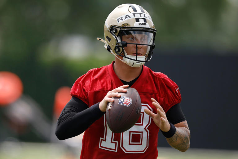 Spencer Rattler needs some coaching on how to paint the Saints' logo