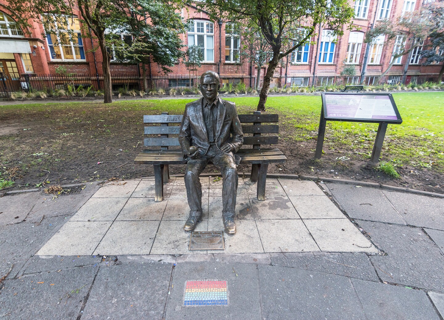 <h2><b>Alan Turing Memorial </b></h2> <h3>Manchester, England</h3> <p> In the middle of <a class="Link" href="https://www.afar.com/magazine/the-best-things-to-do-in-manchester-england" rel="noopener">Manchester’s</a> Sackville Park, a bronze representation of Alan Turing sits patiently on a bench, apple in hand—a reference perhaps to the tree of knowledge and his method of suicide, a cyanide-laced apple. The plaque at his feet reads: “Father of computer science, mathematician, logician, wartime codebreaker, victim of prejudice.” The 20th-century Englishman—whom many learned about when Benedict Cumberbatch portrayed him in 2014’s <i>The Imitation Game</i>—was prosecuted and chemically castrated for homosexual acts during the 1950s. Located near the city’s Gay Village district and the <a class="Link" href="https://www.beacon-of-hope.org.uk/about" rel="noopener">Beacon of Hope</a> HIV/AIDS memorial, the statue was erected in 2001, though it gained greater fame after Queen Elizabeth II posthumously pardoned Turing in 2013. The commemorative statue in Turing’s honor is part of Manchester’s LGBTQ Heritage Trail, also called the <a class="Link" href="https://www.visitmanchester.com/things-to-see-and-do/manchester-heritage-trail-p326171" rel="noopener">Out in the Past Trail</a>, for which small rainbow mosaics are set into the pavement to mark key historic sites.</p>
