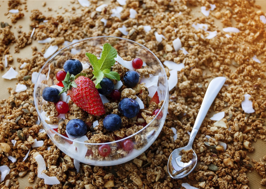 <p>"Granola" was actually first used in the 1870s, when Dr. John Kellogg took the crumbs that fell to the bottom of his oven when he baked whole grain bread and served them for breakfast. He originally called his invention "granula"—which referred to the granular texture of the food—but the word was already trademarked, so he changed the "u" to an "o." Granola came back into popularity in 1970, when food companies started using the word to describe breakfast cereals and snack bars.</p>