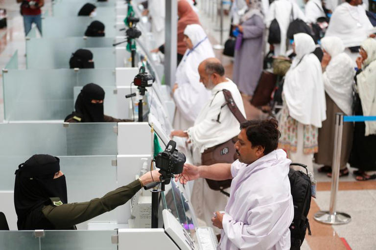 Saudi officers from the national security forces register and check pilgrims at the Hajj Terminal at Jiddah airport, Saudi Arabia