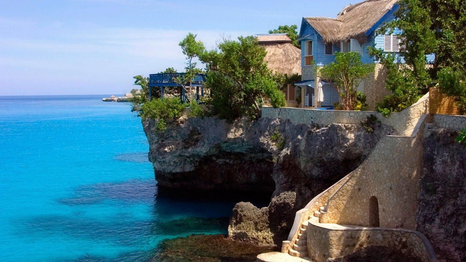 <p>Perched in the picturesque town of Negril, The Caves offers an intimate, cliffside retreat with sweeping ocean views and unique accommodations nestled within natural caves. This boutique hotel features 12 vibrant cottages and suites that blend seamlessly with the surroundings, providing a serene and private escape. </p> <p>One of its standout features is the private cave dining experience, where guests can enjoy romantic candlelit dinners by the sea. With amenities like a saltwater pool, cliff jumping, snorkeling, and a tranquil spa, The Caves delivers an unforgettable blend of adventure, relaxation, and Jamaican charm.</p>