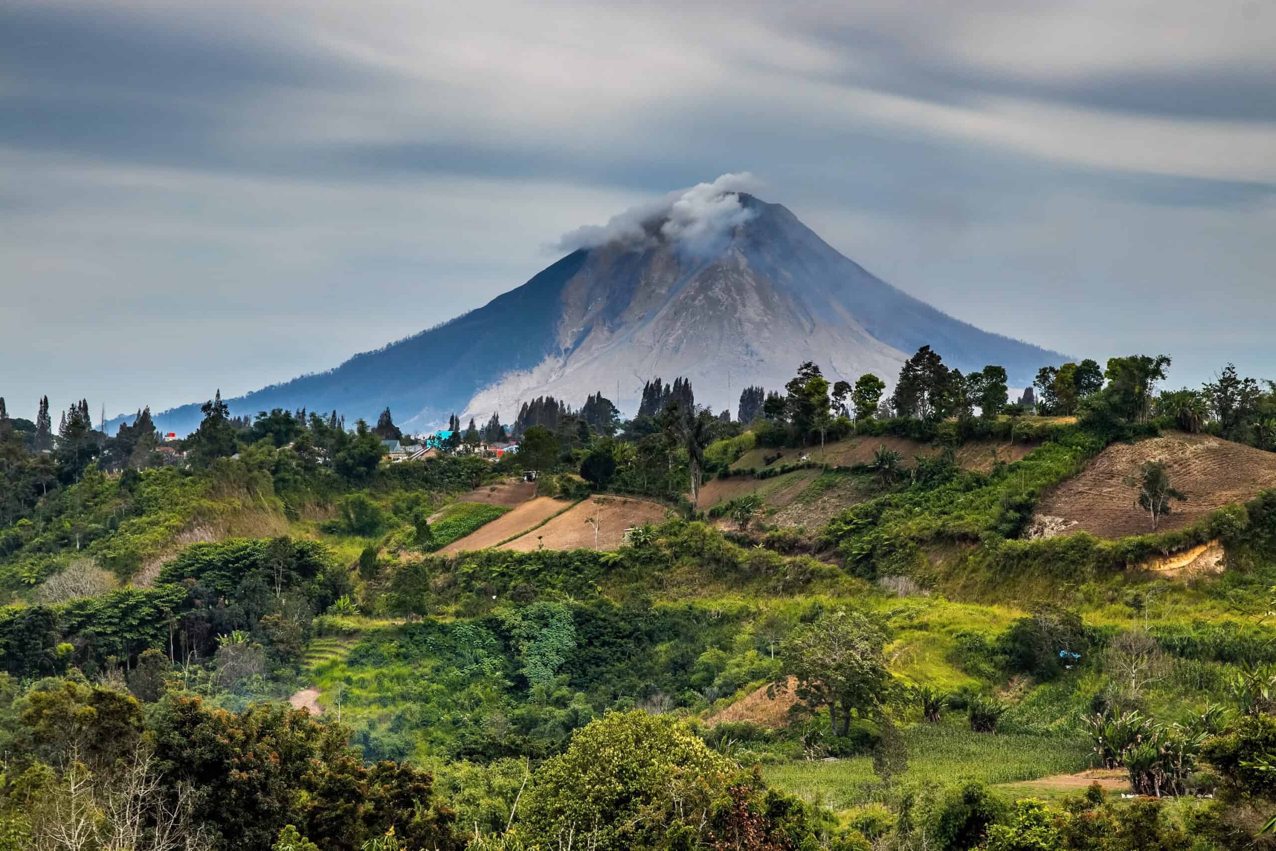 <p>Mount Sinabung, a highly active stratovolcano on Sumatra Island, Indonesia, offers expansive views but is notorious for its frequent and violent eruptions. Dormant for centuries, the volcano reawakened in 2010 and has since caused significant devastation with pyroclastic flows, ash clouds, and lava. </p> <p>Despite the inherent risks, the lush surroundings and dramatic landscape attract hikers and nature enthusiasts eager to experience its awe-inspiring beauty. Visitors must be cautious, as the volcano’s unpredictable activity poses constant danger to the local population and environment.</p>