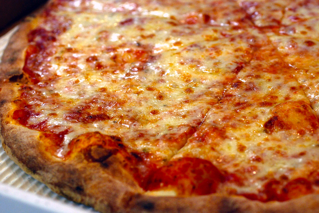 <p>New York-style pizza is renowned for its thin, hand-tossed crust, which is both crispy and foldable. This pizza is often characterized by its large, wide slices and tangy tomato sauce topped with generous amounts of mozzarella cheese. Ideal for eating on the go, New York-style pizza is a staple of city life and is often served with simple toppings like pepperoni or sausage, letting the high-quality ingredients shine through.</p>
