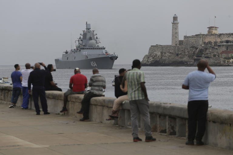 People watch the Russian Navy Admiral Gorshkov frigate arrive at the port of Havana, Cuba, Wednesday, June 12, 2024. A fleet of Russian warships reached Cuban waters on Wednesday ahead of planned military exercises in the Caribbean. (AP Photo/Ariel Ley)