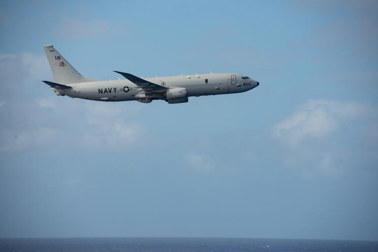 A P-8A Poseidon from the "Pelicans" of Patrol Squadron 45 flies by the aircraft carrier USS Nimitz on February 24, 2023, in the Philippine Sea. Over half a dozen of the maritime patrol aircraft were operating in Florida on June 11 as a Russian navy fleet transited the Florida Straits.