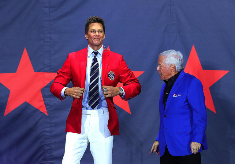 Tom Brady shows off his new red jacket given to him by Robert Kraft as he was inducted into the Patriots Hall of Fame.