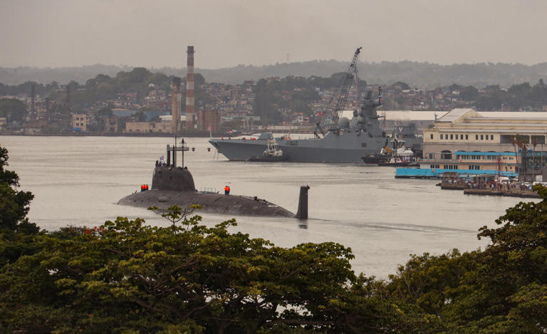 The Russian nuclear-powered submarine Kazan, left, and the class frigate Admiral Gorshkov, part of the Russian naval detachment visiting Cuba, arrive at the port of Havana on June 12. Cuba’s Foreign Ministry said the vessels would not be carrying nuclear weapons and will dock in the Cuban capital from June 12-17.