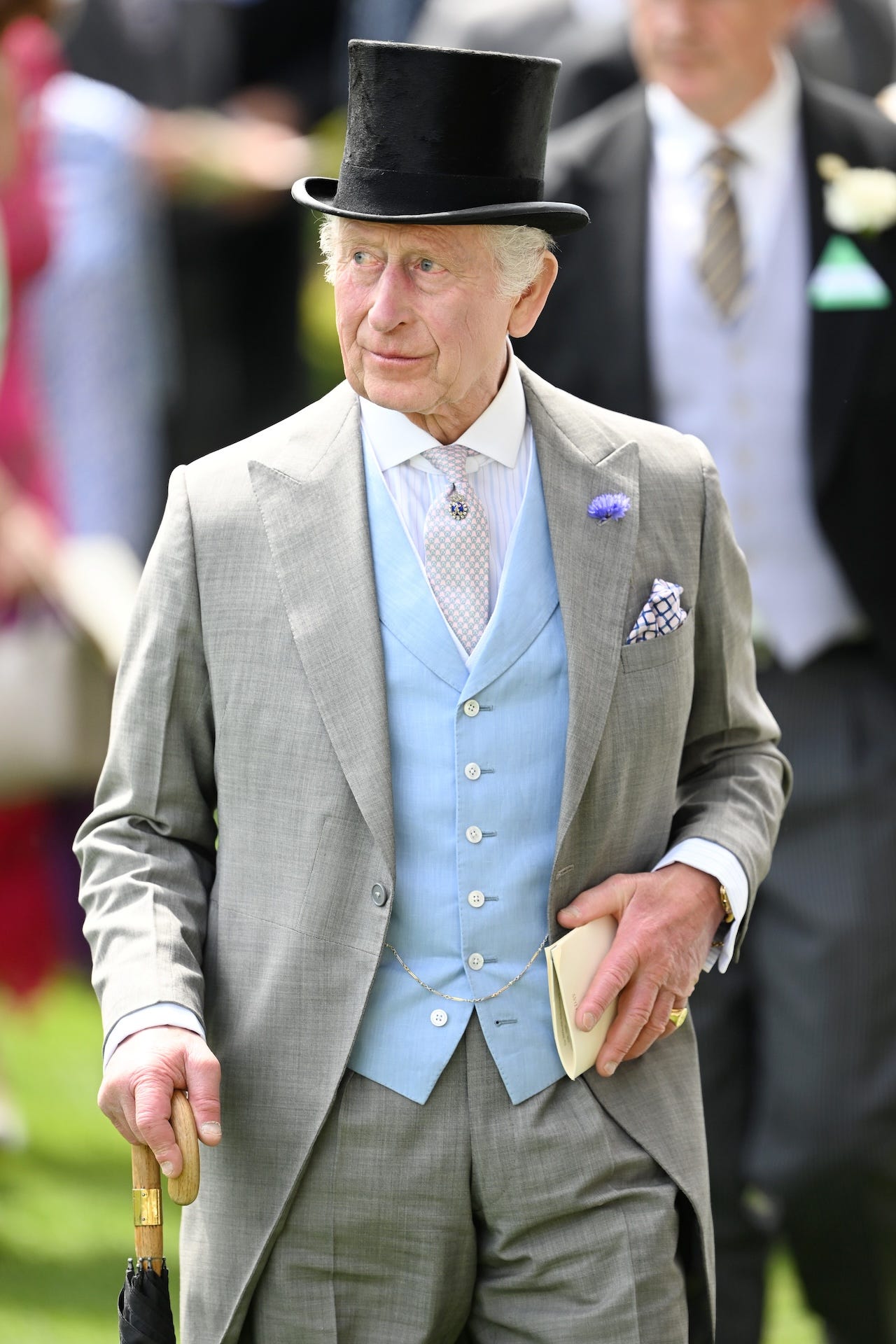 <p>The king paired his traditional gray morning suit with a baby-blue waistcoat, a black-and-white pocket square, and a tiny lilac flower on his lapel. </p><p>As is custom, he paired his look with a black top hat.</p>