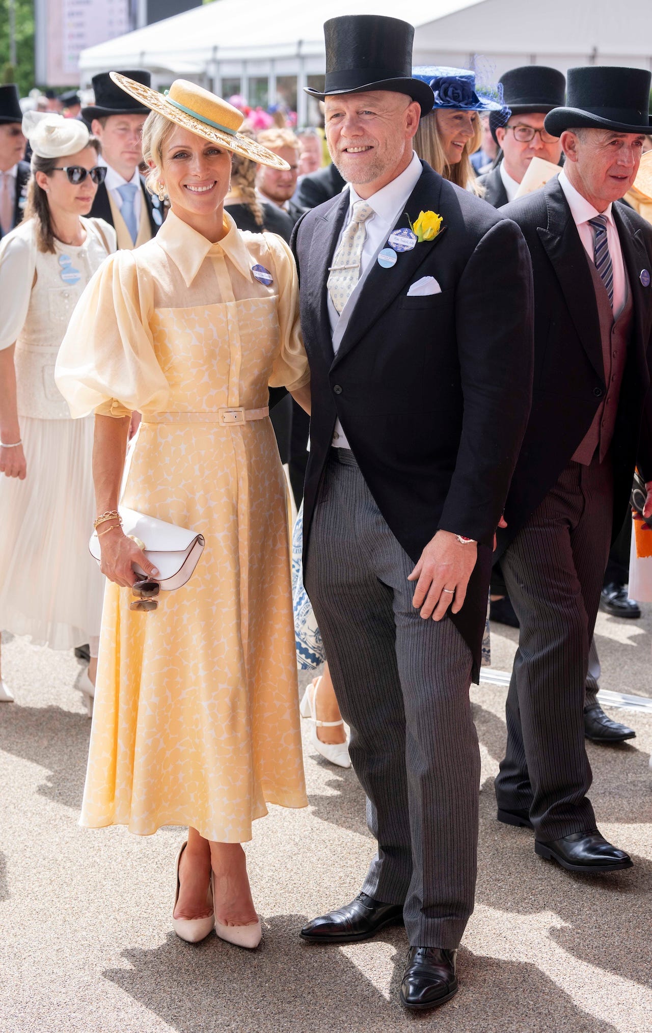 <p>The Tindalls took a note from Charles and Camilla's stylebook and opted for subtly coordinating looks on day one of Royal Ascot.</p><p>Zara, 43, arrived in a yellow dress designed by <a href="https://lauragreen.com/product/masai/">Laura Green</a>. The "Masai" dress features sheer silk sleeves and a dramatic collar and retails for £1,900, or around $2,400.</p><p>Mike, 45, wore a morning suit and accessorized his jacket lapel with a canary yellow rose, a nod toward his wife's look.</p>
