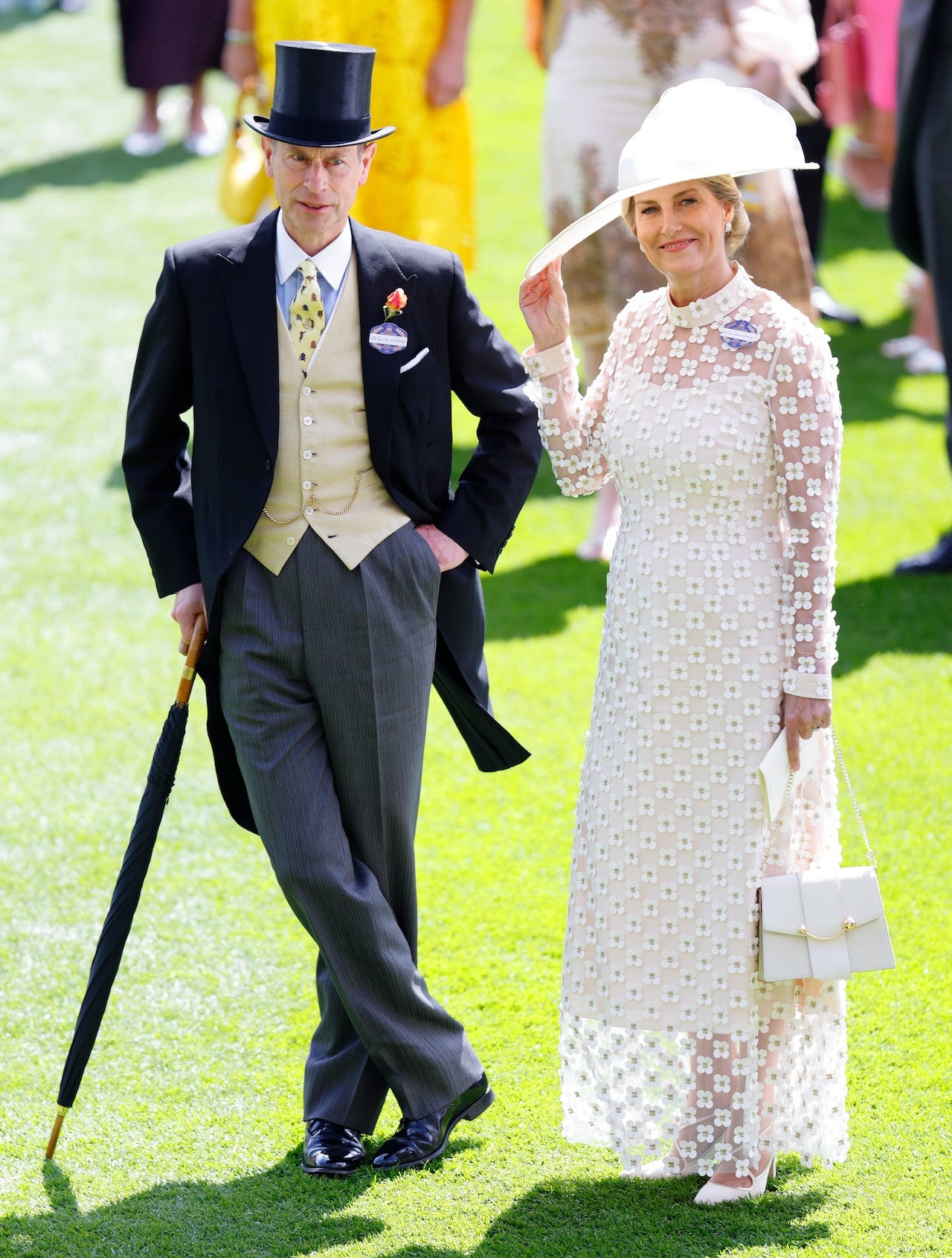 <p>Edward, 60, kept to the dress code, pairing a black morning suit jacket with a collared shirt, a light-yellow waistcoat, and a black tie. He did add a pop of individuality to his look with a bright-yellow tie.</p><p>The prince was accompanied by his wife, Sophie, 59, who wore an ivory dress designed by <a href="https://www.suzannah.com/en-us/products/keres-dress-ivory">Suzannah London</a>. The "Keres" dress, which retails at $4,950, features a sheer tulle layer covered in mini daisies over a simple crepe dress. The Duchess of Edinburgh paired it with a wide-brimmed white hat and a coordinating handbag.</p>