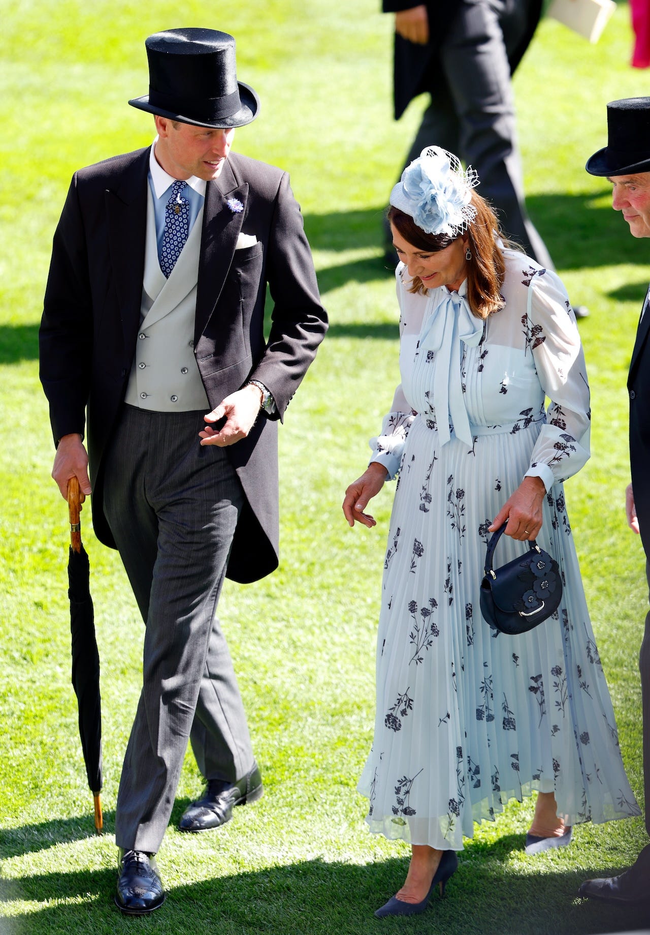 <p>Following the dress code to a tee, William, 41, arrived in a black morning suit jacket, gray pants, and a black top hat. He paired it with a double-breasted waistcoat layered over a collared shirt and a blue patterned tie. </p><p>Although he arrived without <a href="https://www.businessinsider.com/kate-middleton-surgery-public-absence-what-to-know-2024-2">Kate Middleton</a>, who is undergoing cancer treatment but <a href="https://www.businessinsider.com/kate-middleton-trooping-the-colour-first-event-since-cancer-announcement-2024-6">plans to attend several royal engagements throughout the summer</a>, William wasn't alone at the races. Aside from the company of his royal family members, he was photographed smiling and chatting with his in-laws, Michael and <a href="https://www.businessinsider.com/the-crown-carole-middleton-kris-jenner-comparison-royal-experts-2023-12">Carole Middleton</a>. </p>
