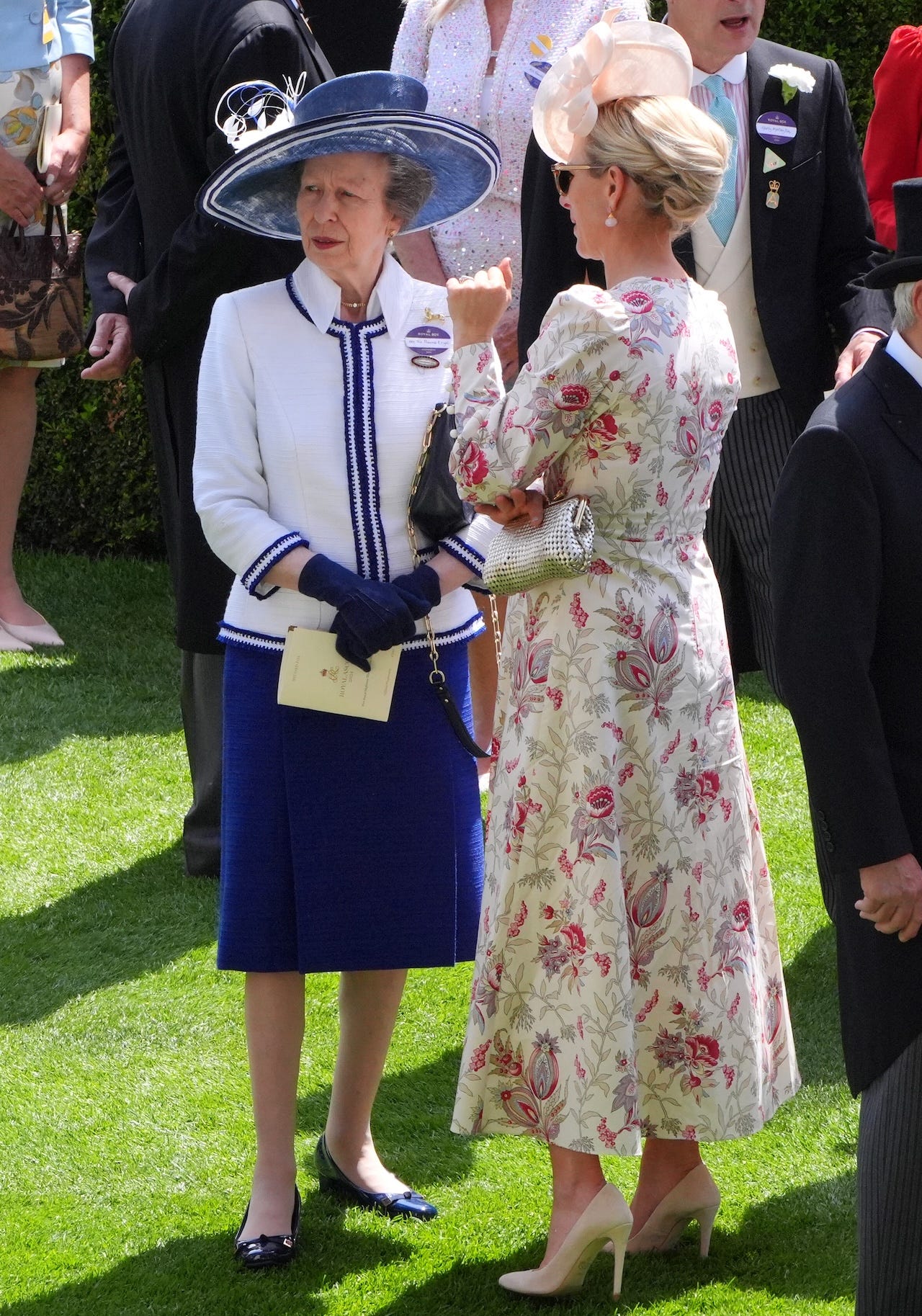 <p>Anne paired a royal-blue midi skirt with a white jacket with blue trim layered over a collared shirt.</p><p>Although her look was tame compared to her outfit on day one, she did accessorize with a sizable blue-and-white hat decorated with floral appliqué.</p>