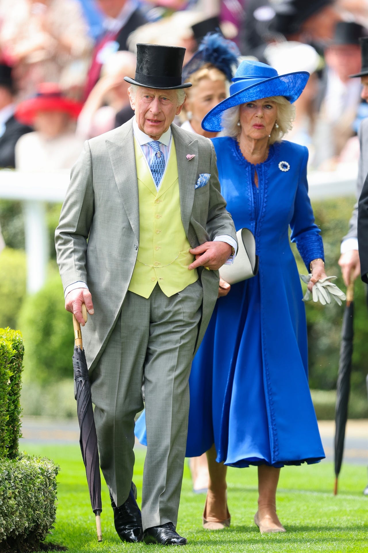 <p>Charles, 75, wore a light-gray morning suit layered over a pale-yellow waistcoat and a striped collared shirt topped off with a black top hat. The king completed his look with a blue tie and pocket square, subtly coordinating with his date, Camilla, 76.</p><p>For her Royal Ascot day one ensemble, Camilla opted for a royal-blue coat and dress by Fiona Clare, accessorized with a brooch, a white clutch, gloves, and, of course, an eye-catching blue summer hat designed by veteran British milliner and go-to hat designer for the royals, Philip Treacy.</p>