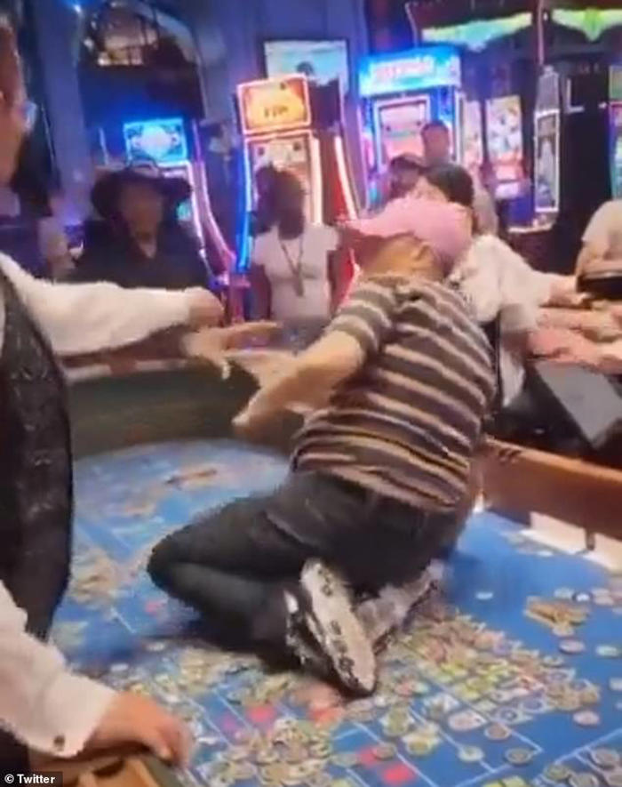 moment woman climbs onto casino table and flings chips into the air