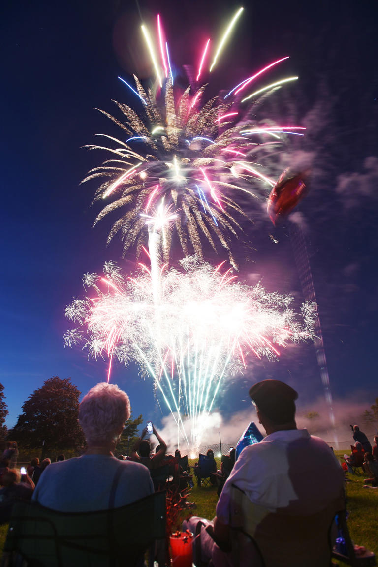 Fireworks for the 4th of July celebration are seen in the sky as people watch at Brookdale Park in Montclair on July 3rd, 2017.