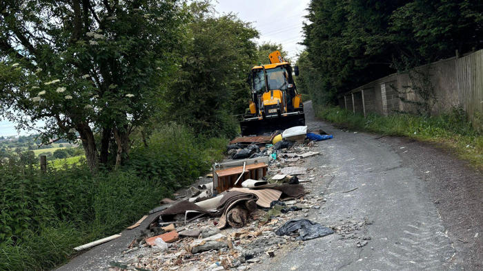 bath and carpets among rubbish fly-tipped on road