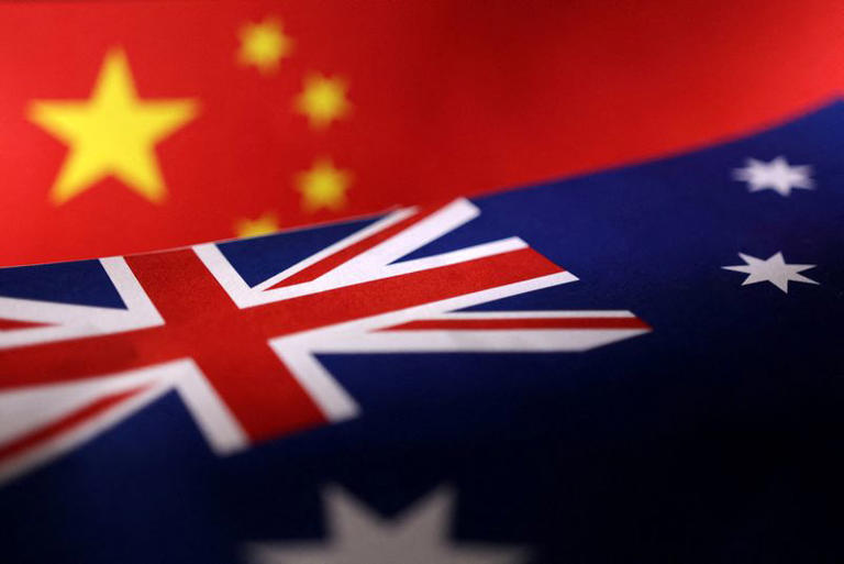 Printed Chinese and Australian flags are seen in this illustration, July 21, 2022. REUTERS/Dado Ruvic/Illustration/File Photo