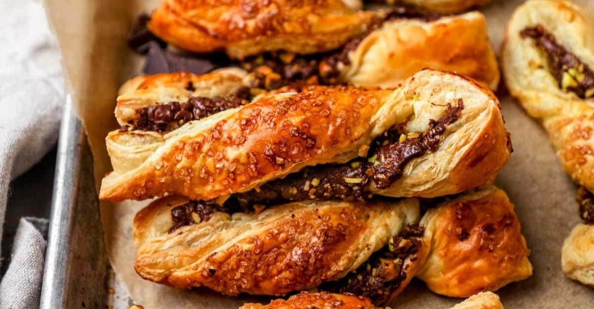 <p>Wrap puff pastry ribbons around a layer of Nutella and chocolate, twist them, and then pop them into the oven. Add crunchy pistachios to this golden brown delicacy and serve with your favorite beverage.</p> <p>Get the recipe: <a href="https://theheirloompantry.co/puff-pastry-chocolate-nutella-twists/?fbclid=IwZXh0bgNhZW0CMTAAAR0ufhR1F2Jtk27adc1MOXsIsLbd8x2tiCyaI4pZsl8gmwijnk3N5tMoxbU_aem_ZmFrZWR1bW15MTZieXRlcw" rel="noreferrer noopener">Puff Pastry Chocolate Nutella Twists </a></p>