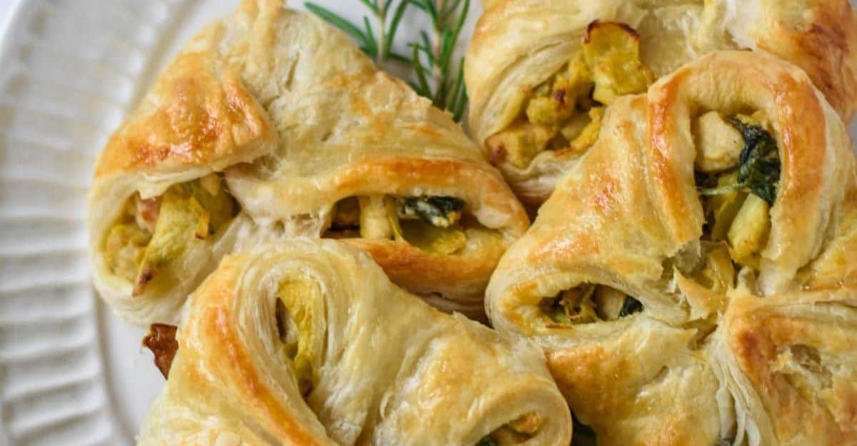 <p>Tender chicken breasts, spinach, creamy Boursin cheese, and puff pastry mix to make the perfect holiday meal. Spice it a bit with your favorite herbs and enjoy.</p> <p>Get the recipe: <a href="https://thedizzycook.com/artichoke-chicken-in-puff-pastry/?fbclid=IwZXh0bgNhZW0CMTAAAR2WdisUzWZRB19fw1Uuvfr7jzPcNqlzfqSgVMUFWtD_UvVPQpBHqoLw31E_aem_ZmFrZWR1bW15MTZieXRlcw" rel="noreferrer noopener">Chicken In Puff Pastry</a></p>