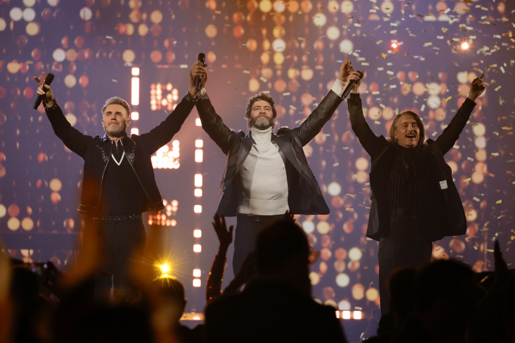 You could barely move in the early part of the 90s for Take That, with the band racking up hits at a rate of knots - from Relight My Fire to Pray. But what of their name? There's no big mystery as to how they got it - having chosen it from a shortlist - but the five-piece, formed by manager Nigel Martin-Smith, didn't start out as Take That. Planet Radio revealed that alternative names included Kick It and The Cutest Rush, before they settled on the name which Gary Barlow has previously called 'the best of a bad bunch'. 'There have been times when we've been a bit embarrassed about our name,' Mark Owen told The Sun. 'We used to apologise when we introduced ourselves saying 'We're Take That' and thought we should be called something different' (Picture: The National Lottery)