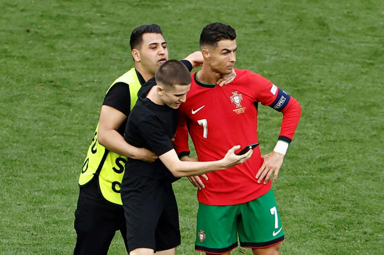 portugal coach bemoans risk to player safety as pitch invaders chase ronaldo selfies